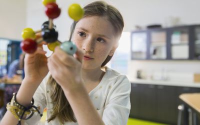 child looking at a molecular model