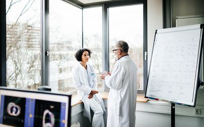 Two researchers discussing study results